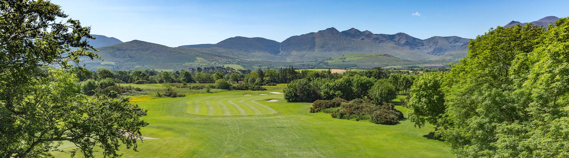 view of golf course and mountains